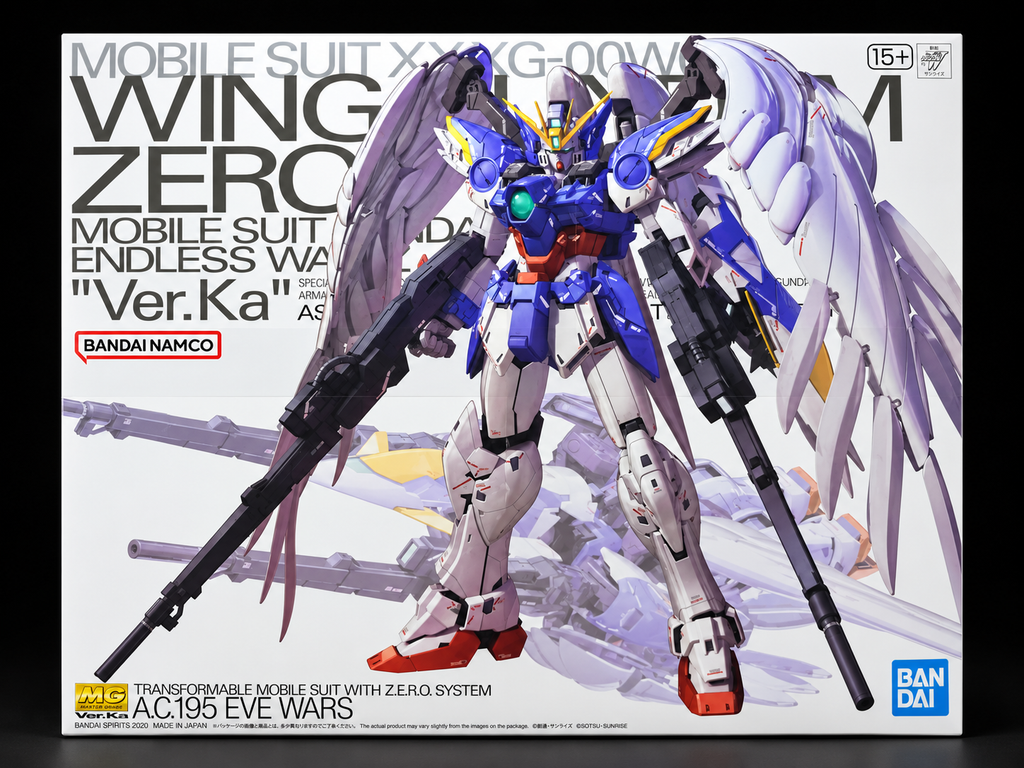 Box art for a Bandai Namco Gundam model kit featuring a blue, white, and gray mobile suit with large wings and two rifles, on a white background with product text.