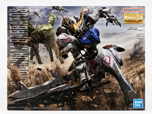 Bandai Namco MG 1/12 scale model kit box for the Gundam BreakThrushter, featuring dynamic sci-fi battle artwork with a silver, blue, and white mecha in a desert battlefield scene.