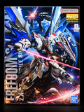 Box art for a Bandai Namco MG Gundam Seed Freedom Seed mobile suit model kit, featuring a detailed sci-fi mecha in space with a red laser beam and Earth in the background.