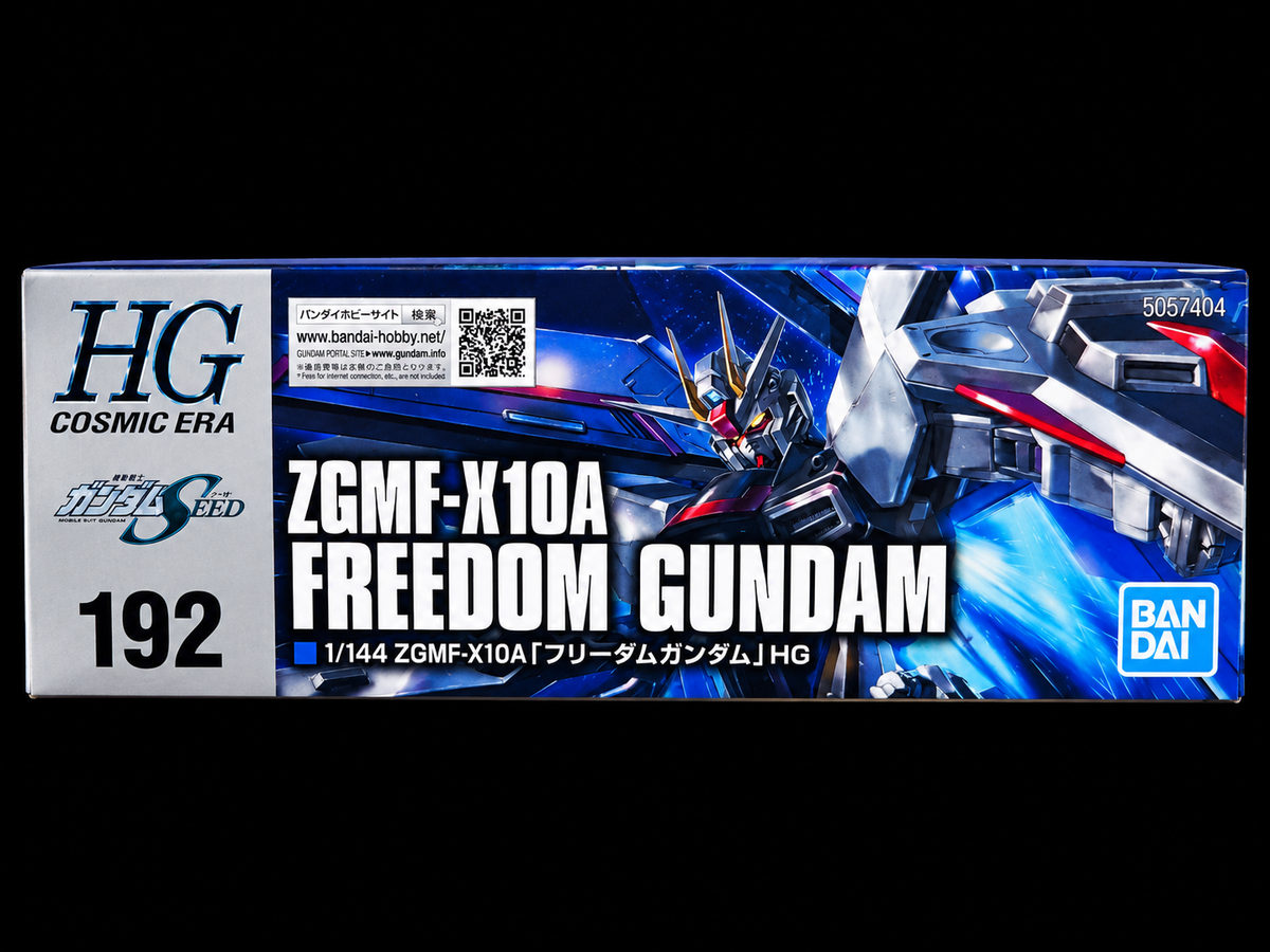 Bandai HG Cosmic Era ZGMF-X10A Freedom Gundam model kit box, featuring blue and white artwork of the mecha on a black background.