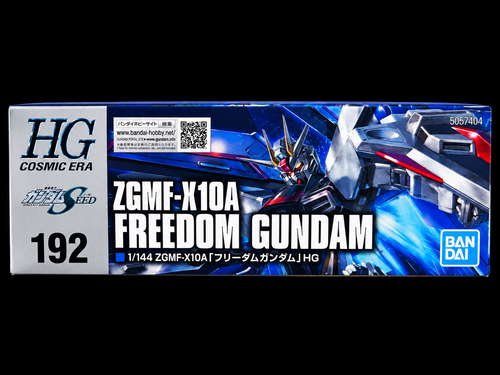 Bandai HG Cosmic Era ZGMF-X10A Freedom Gundam model kit box, featuring blue and white artwork of the mecha on a black background.